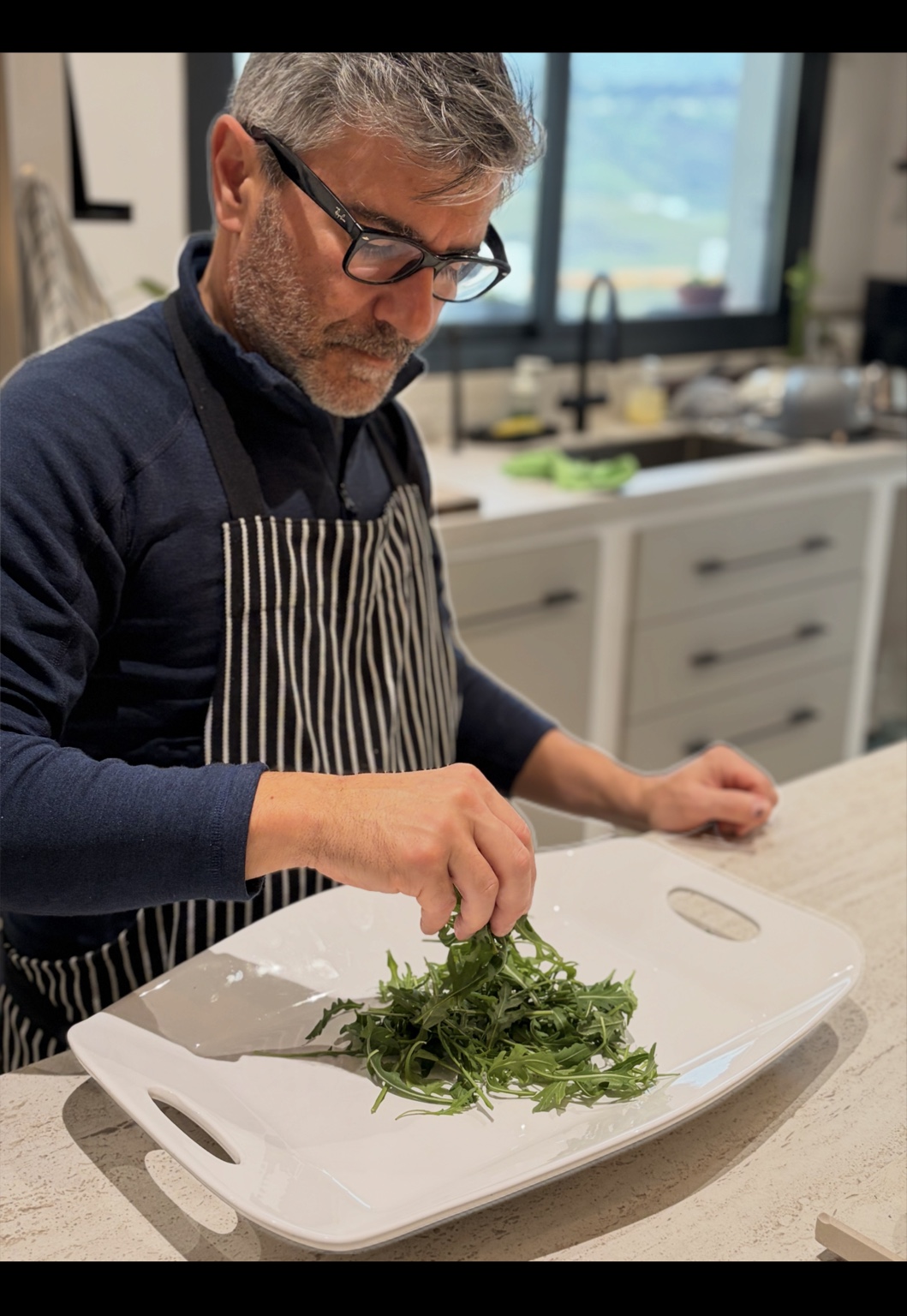 Sal carefully preparing a platter in his kitchen